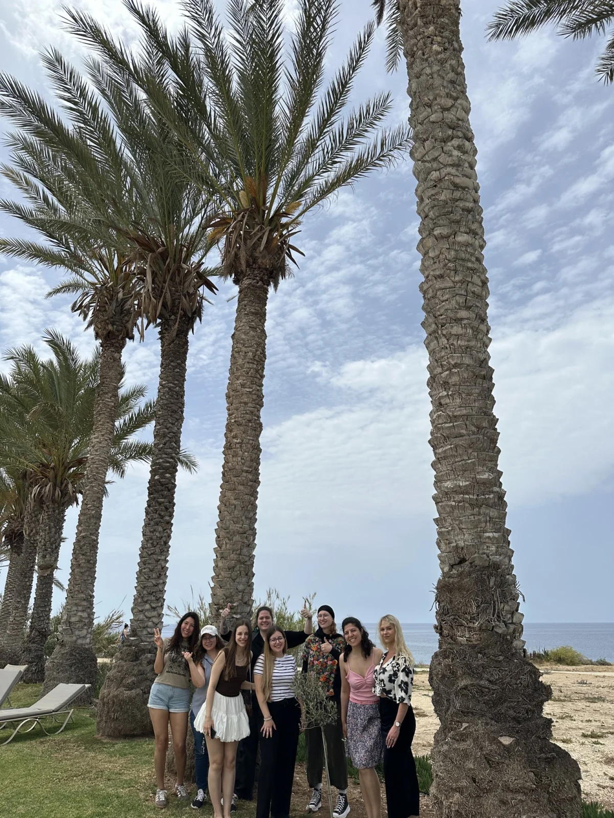 Participants from five countries posing during the Citizens of Tomorrow youth exchange by the seaside in Paphos