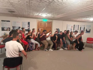 Youth workers participating in a seated circle session focused on well-being strategies during the A Journey to Well-Being Erasmus+ training course.