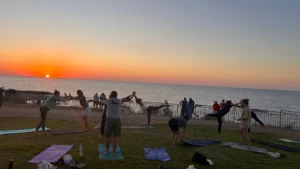 Participants practising yoga at sunset during the A Journey to Well-Being Erasmus+ training course in Paphos.