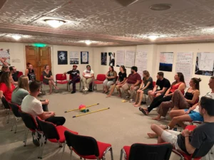 Participants performing a trust-building activity during the A Journey to Well-Being Erasmus+ training course hosted by YETF.