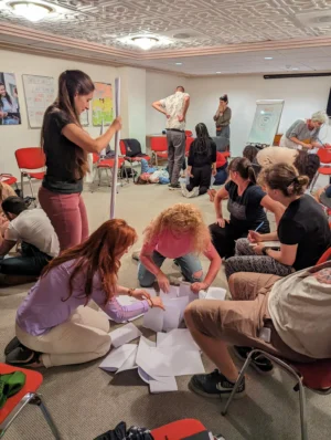 Participants working together on a group challenge using non-formal education methods during the Level Up Your Leadership Skills project.