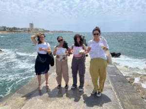 Four participants holding high-five activity papers during the Level Up Your Leadership Skills Erasmus+ training course in Paphos.