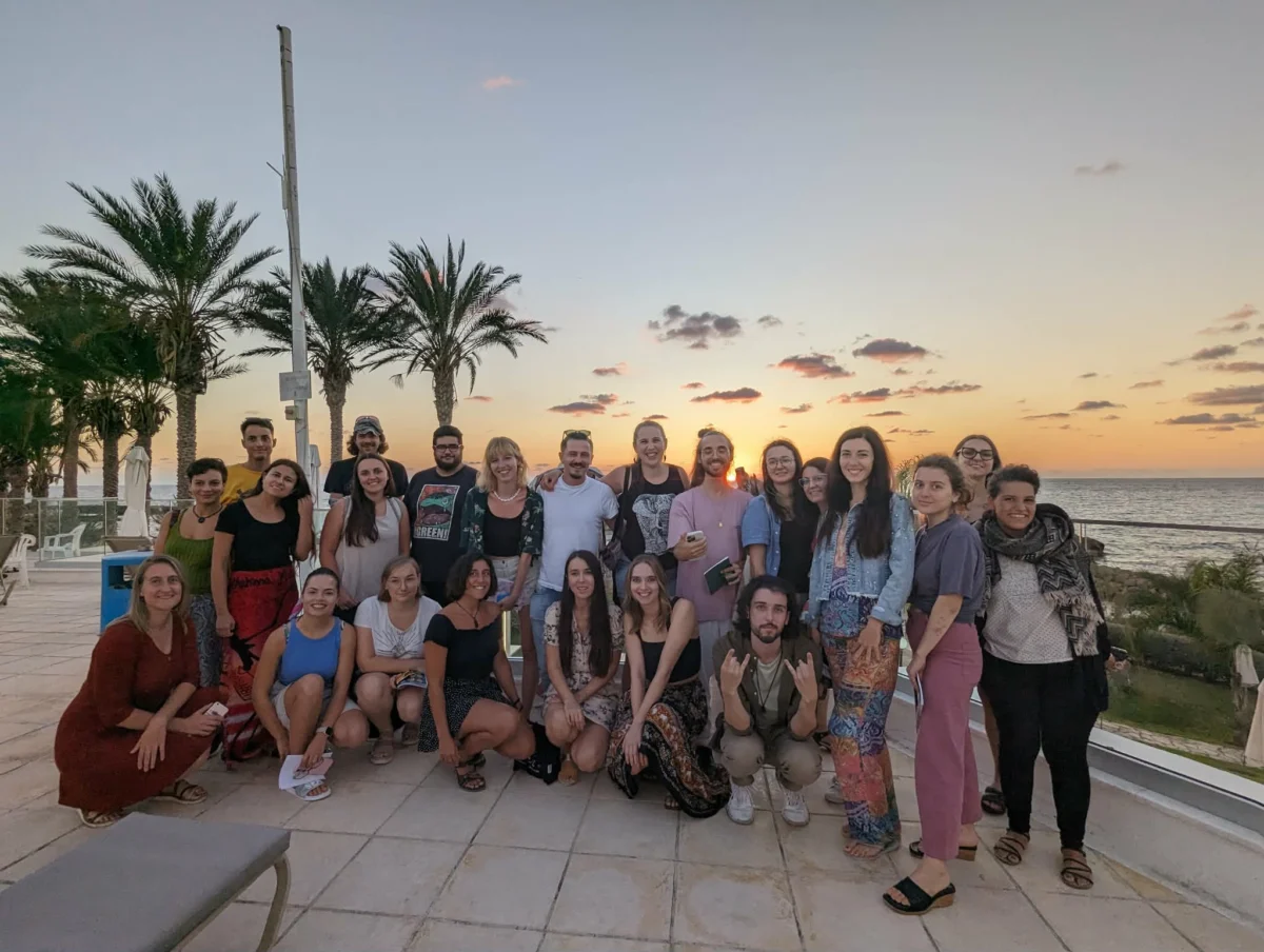 Group photo of participants at sunset during the Make It Happen Erasmus+ strategic training course hosted by YETF in Paphos.