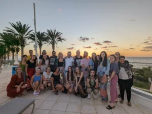 Group photo of participants at sunset during the Make It Happen Erasmus+ strategic training course hosted by YETF in Paphos.