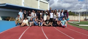 Group photo of youth workers participating in the EU Teams for EU Dreams training course, gathered on the track field in Paphos.
